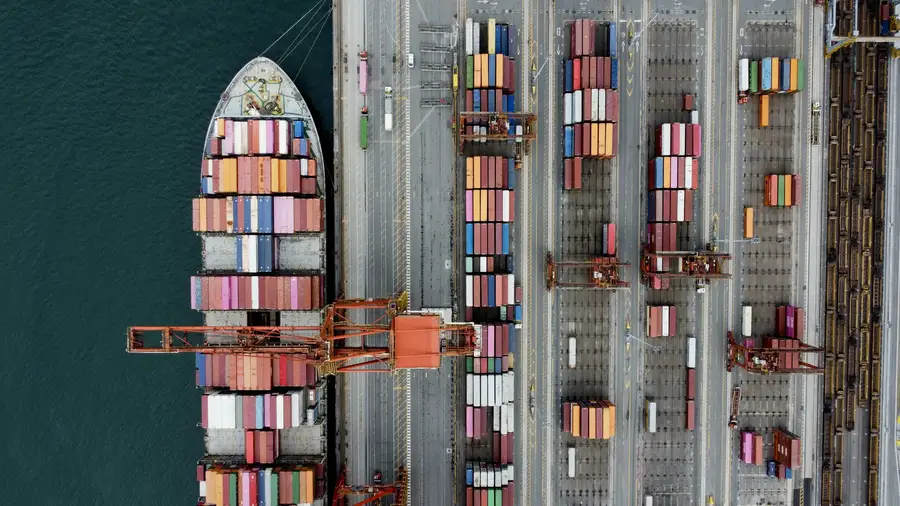 Aerial view of cargo ship at port representing global trade routes